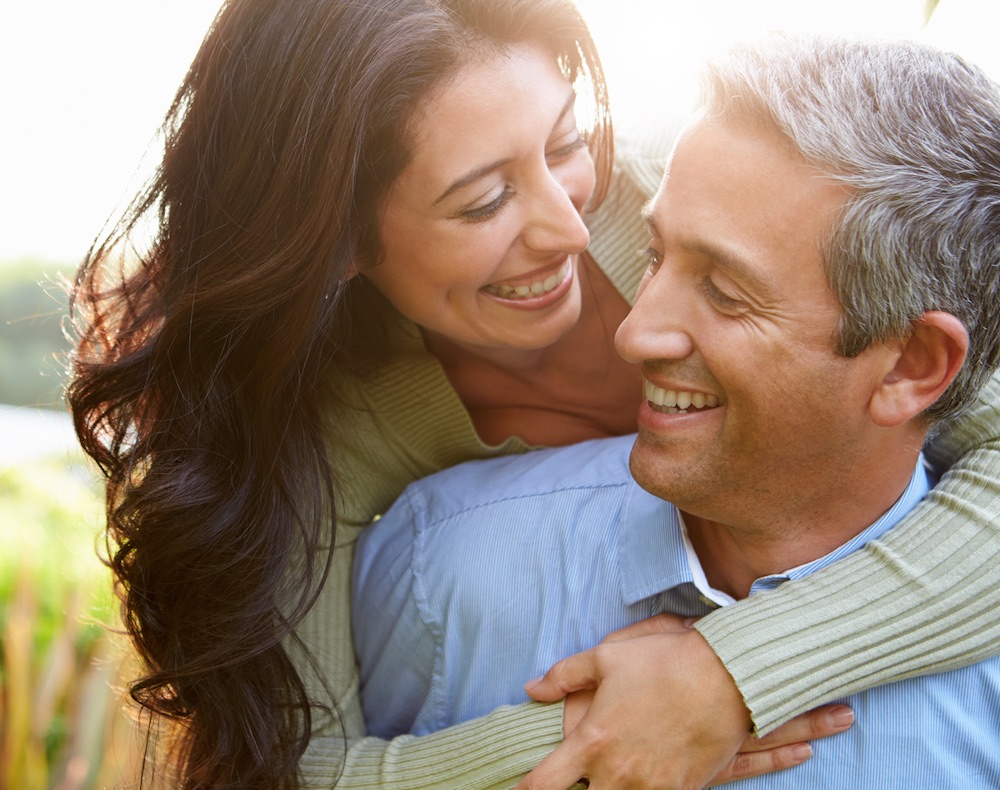 Loving Hispanic Couple In Countryside